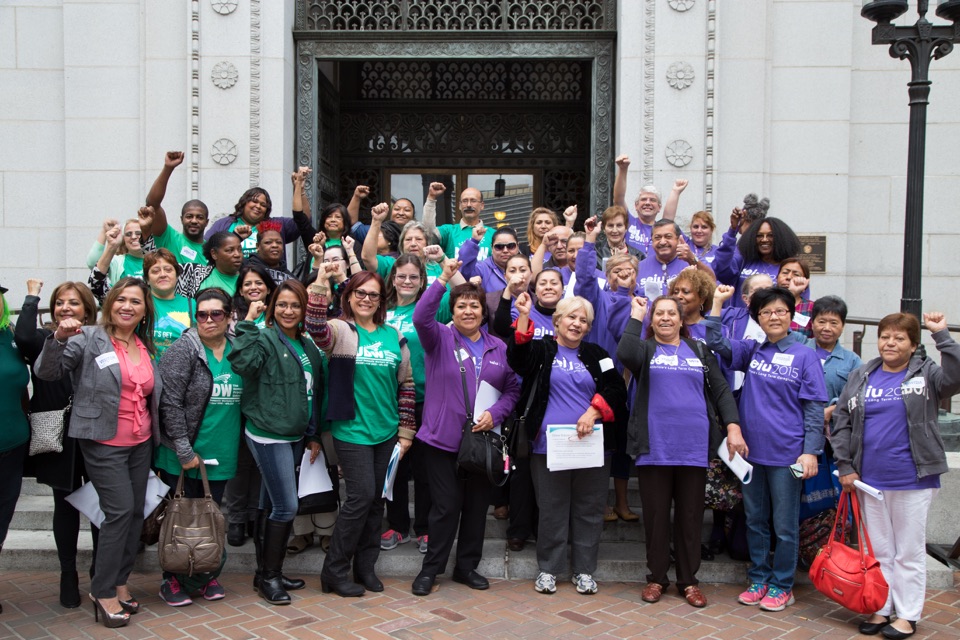 SEIU 2015 and UDW members gathered outside a building with raised fists