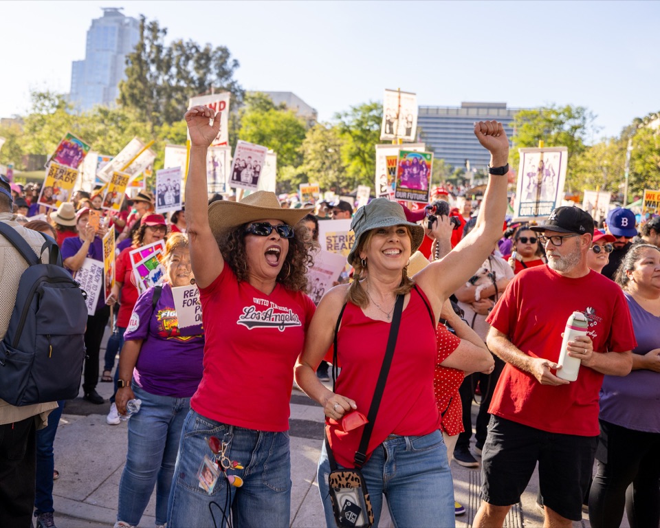 UTLA members cheering with raised fists at a labor rally